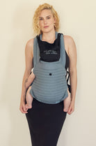 The Armadillo Baby Carrier in Lou Blue worn by Rumer Willis