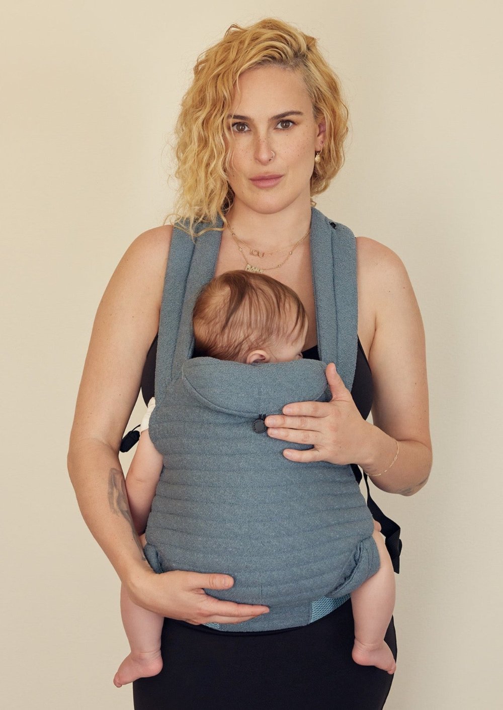 The Armadillo Baby Carrier in Lou Blue worn by Rumer Willis