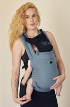 The Armadillo Baby Carrier in Lou Blue worn by Rumer Willis