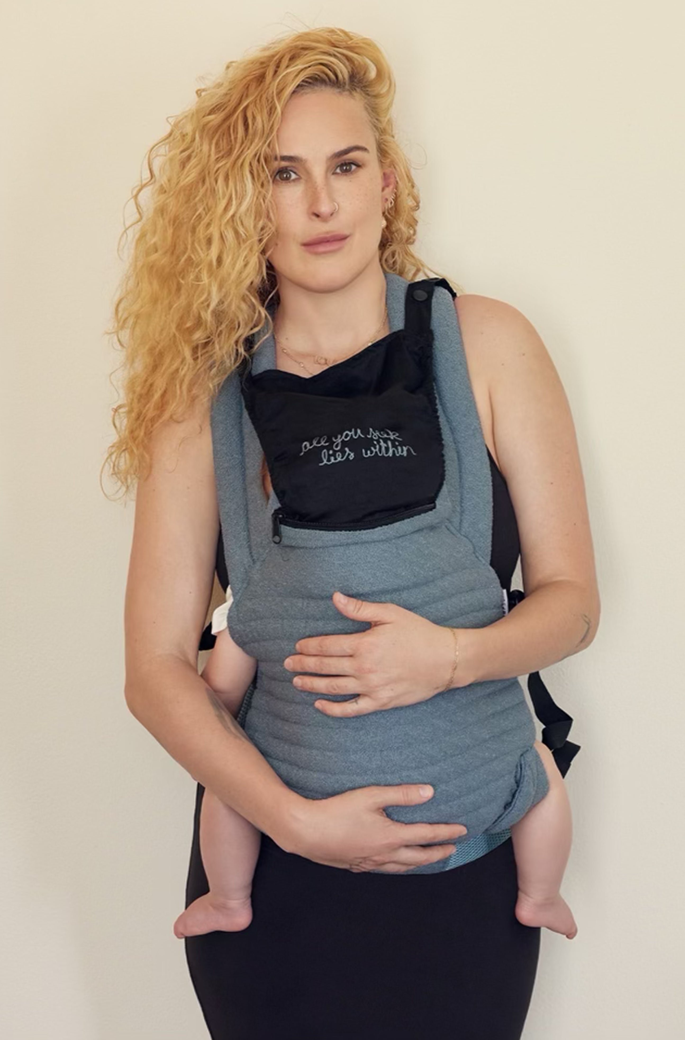 The Armadillo Baby Carrier in Lou Blue worn by Rumer Willis