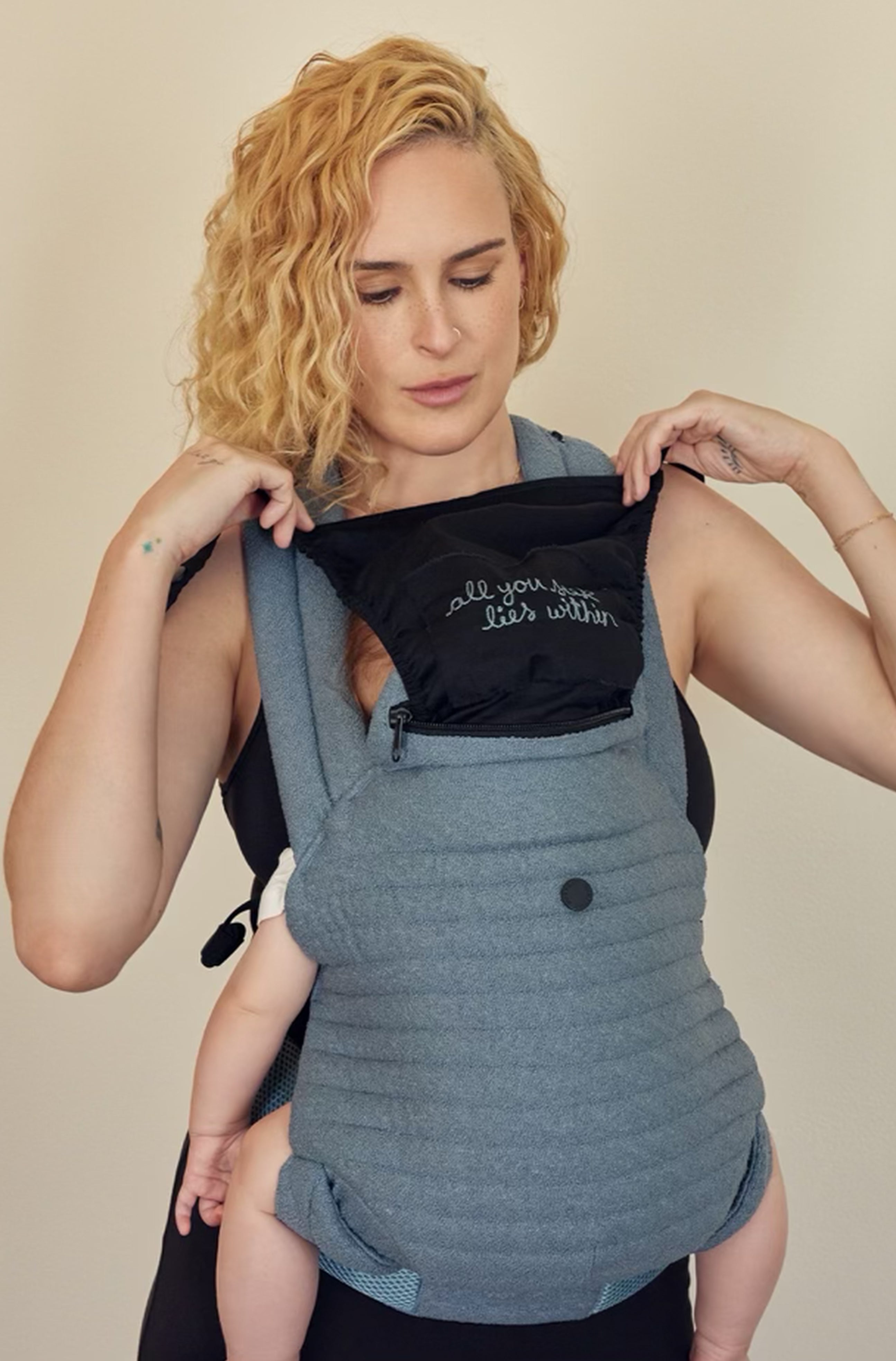 The Armadillo Baby Carrier in Lou Blue worn by Rumer Willis