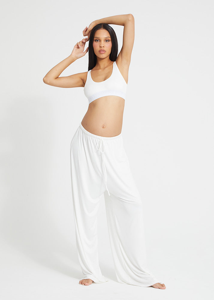 nara smith wearing bumpsuit's parachute pant in ivory