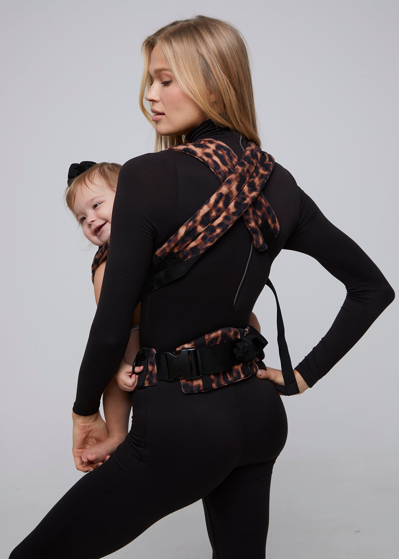 bumpsuit the armadillo baby carrier in leopard worn by vita sidorkina