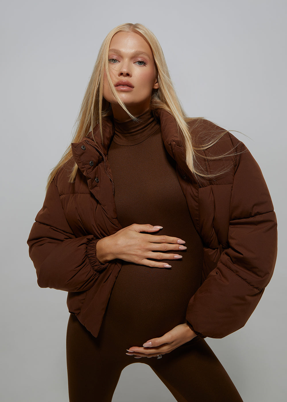 Bumpsuit Maternity Cropped Puffer Jacket in Chocolate worn by Vita Sidorkina