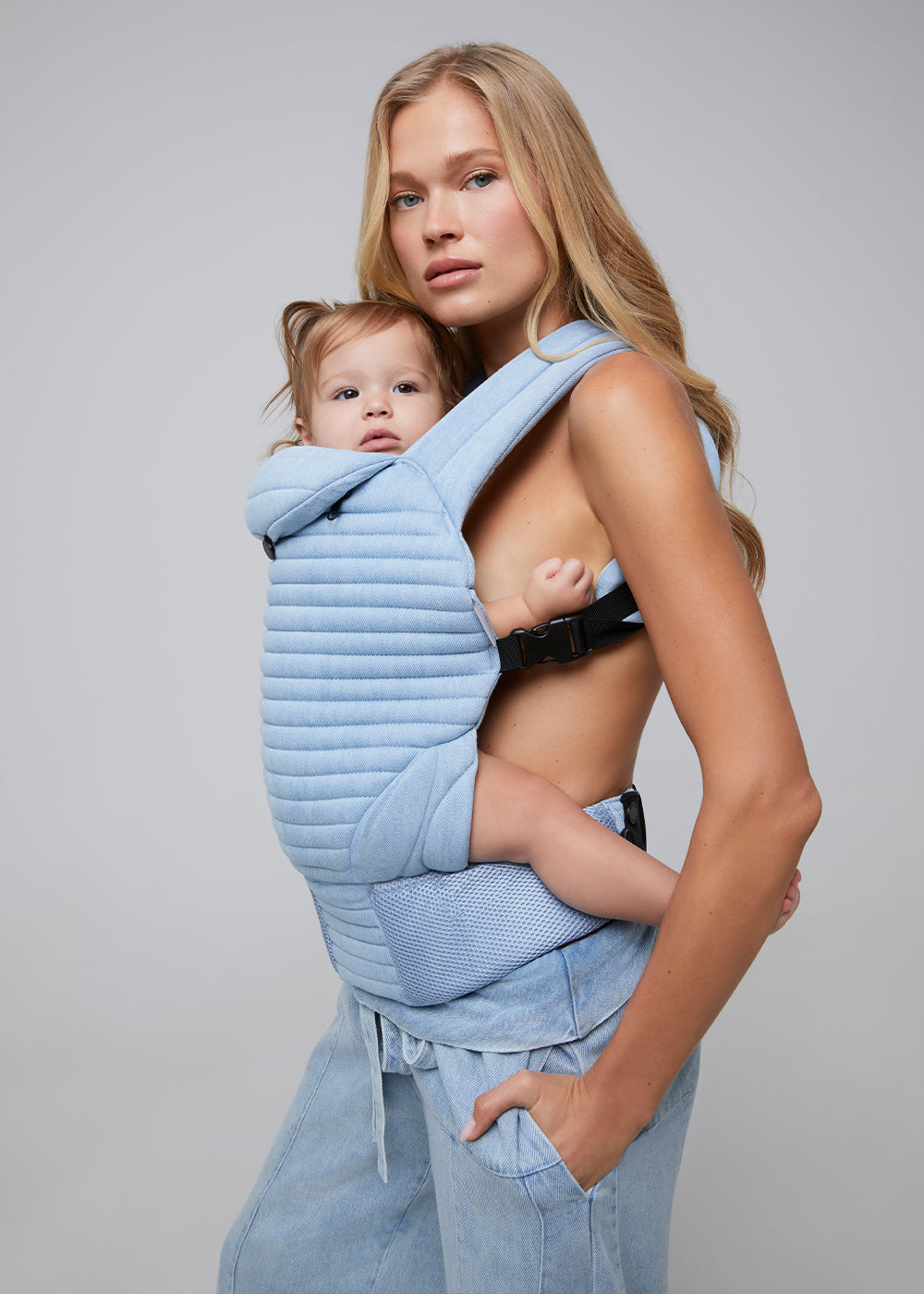 the armadillo baby carrier by bumpsuit in light denim