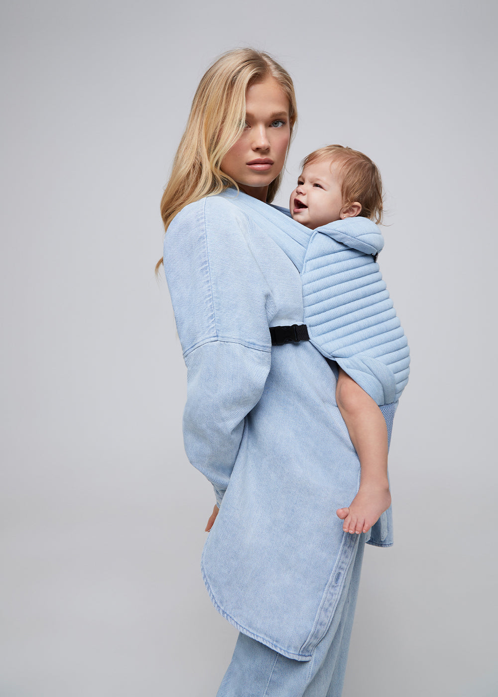 the armadillo baby carrier by bumpsuit in light denim