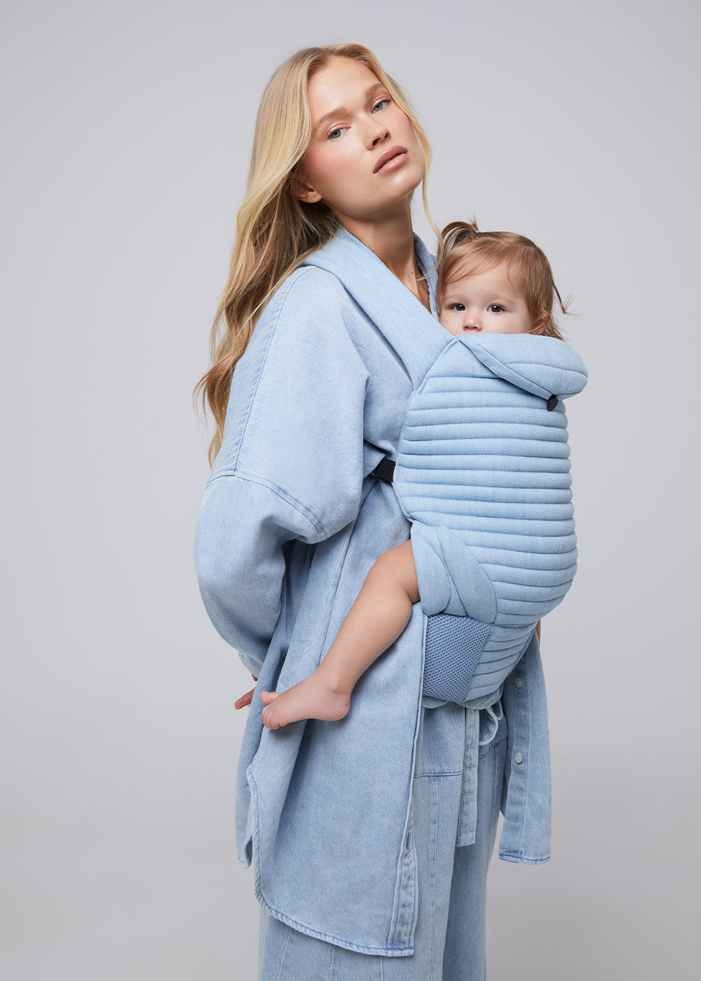 the armadillo baby carrier by bumpsuit in light denim