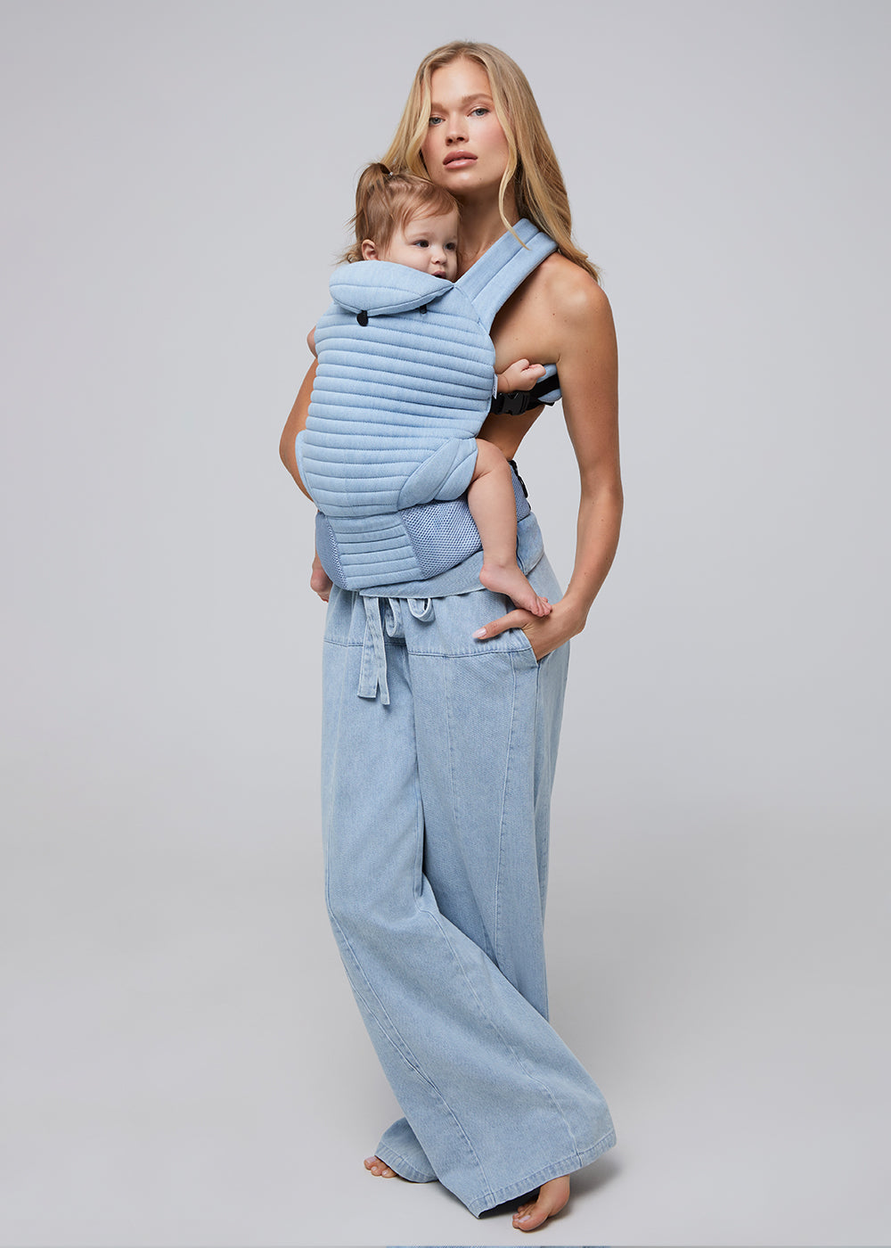 the armadillo baby carrier by bumpsuit in light denim